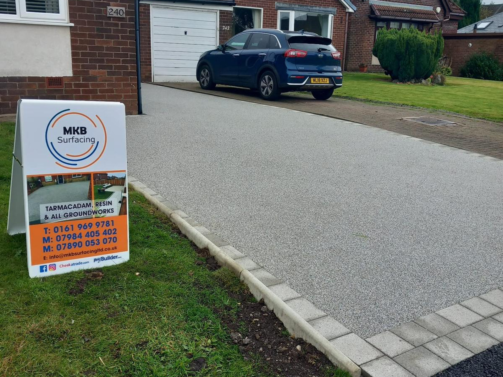 Resin driveway finished with light stone block edging