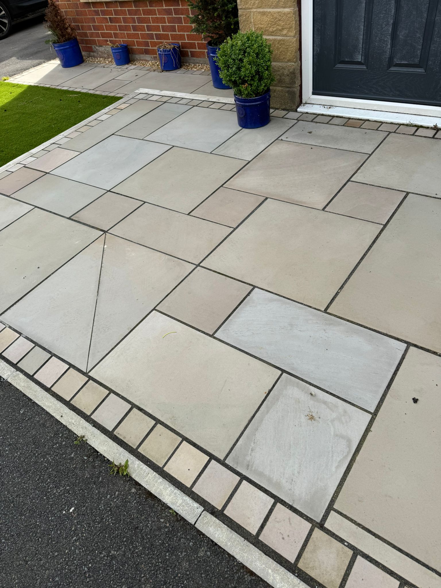 Natural stone paving path to front door with block border — North West England