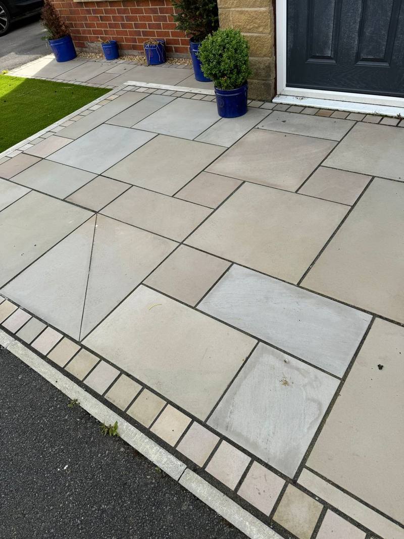 Natural stone paving path to a front door with block border