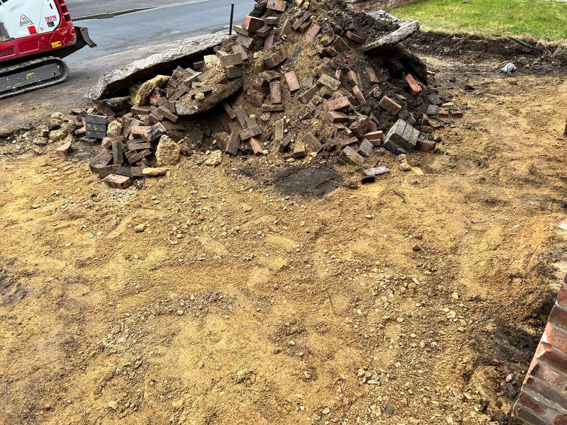 Site preparation and excavation with a mini-digger before a new surface